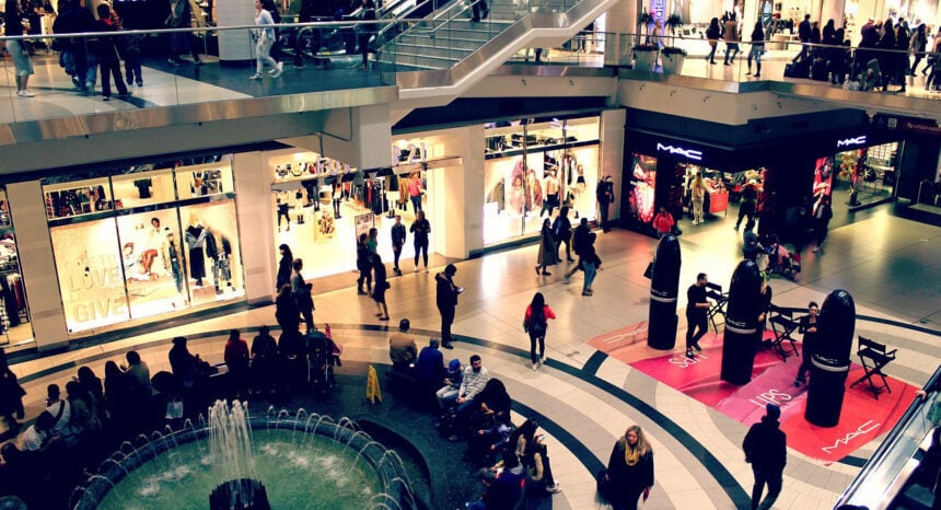 Shoppers walking through a busy indoor retail shopping center